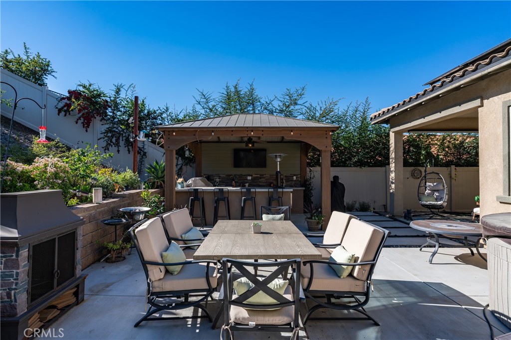 11137 Briar Rose Court Corona, CA 92883 - Photo 53 of 75 a view of a patio with a table and chairs