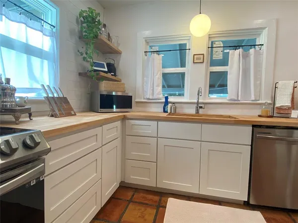 a kitchen with a sink stove and cabinets