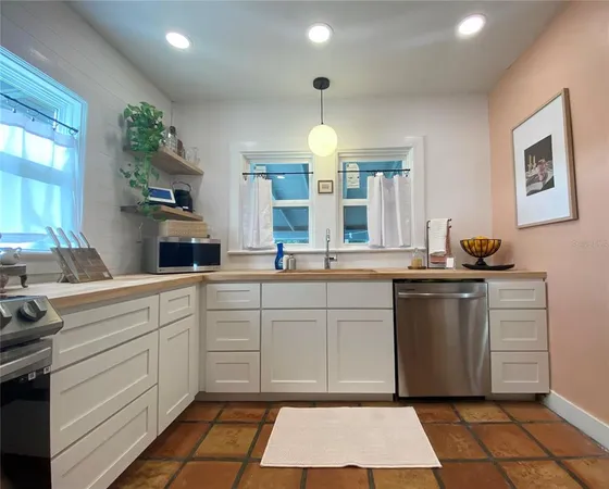a kitchen with a sink cabinets and window