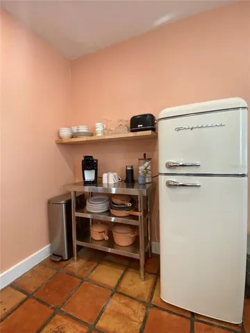 a view of kitchen with refrigerator and stove