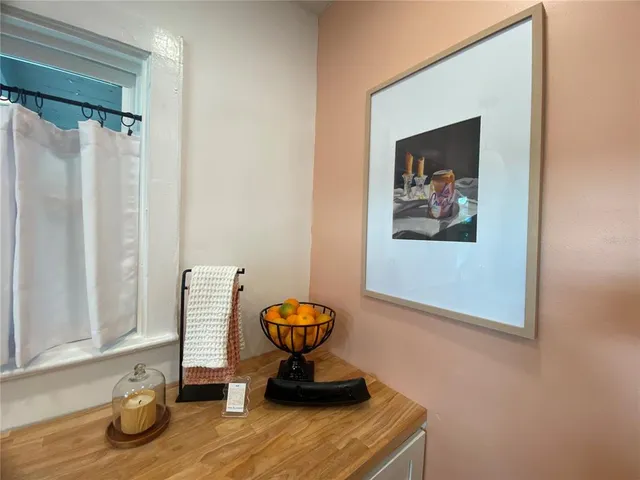 a view of a room with wooden floor and furniture