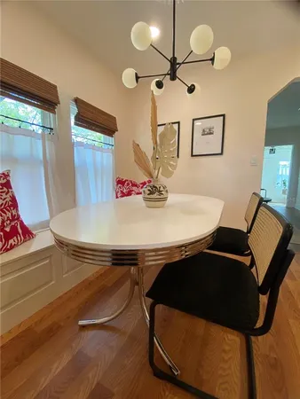 a view of a dining room with furniture and a chandelier fan