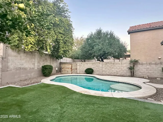 a view of a swimming pool with a yard