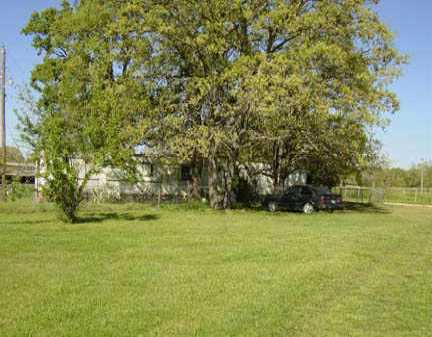 384 Old Lexington Road Elgin, TX 78621 - Photo 1 of 1 a view of a field with trees in the background