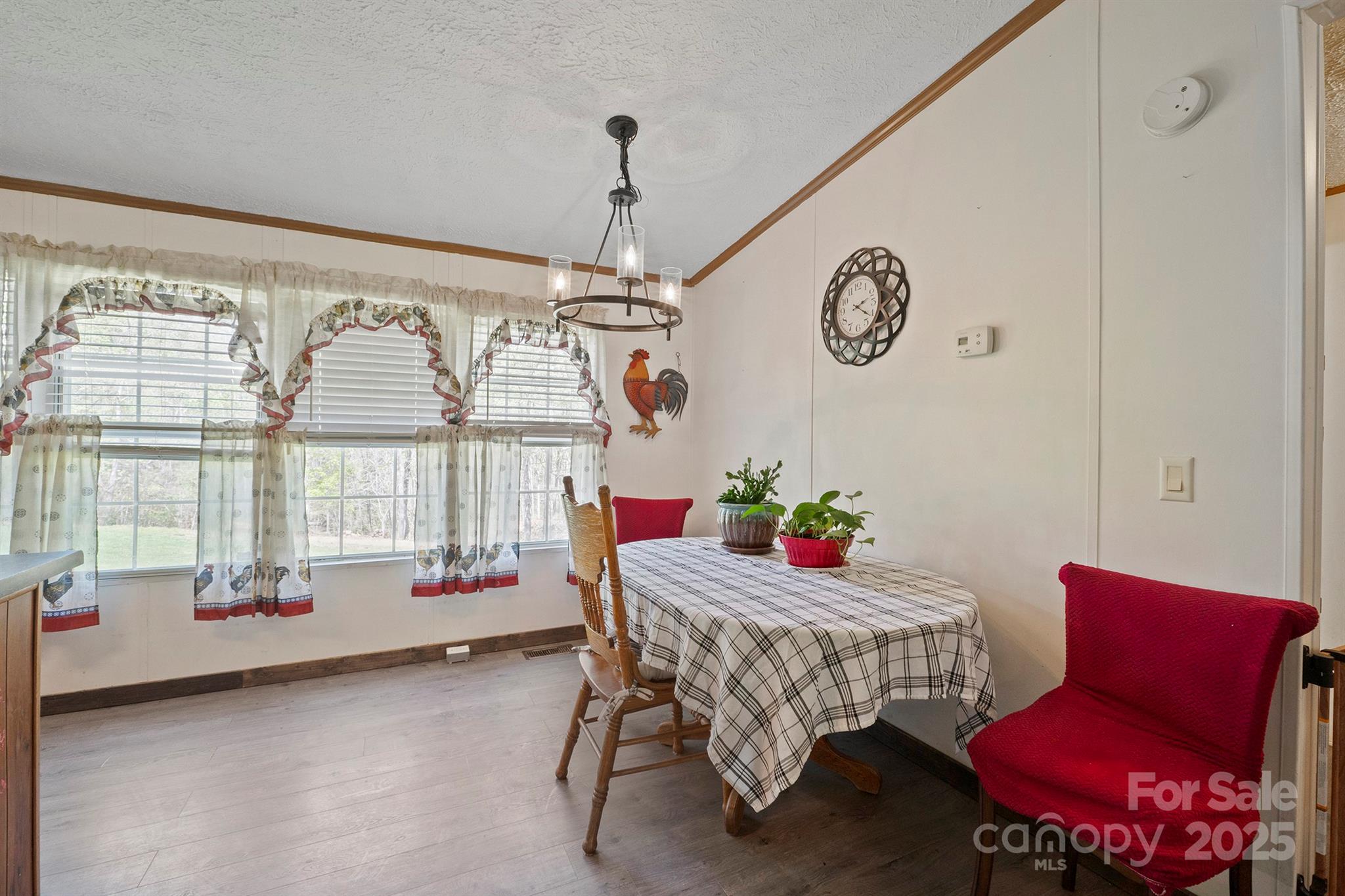 6282 Lor Road Morganton, NC 28655 - Photo 12 of 22 a dining room with furniture a chandelier and a rug