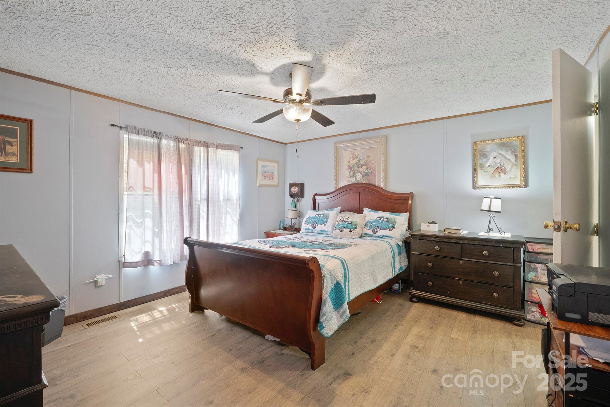 6282 Lor Road Morganton, NC 28655 - Photo 14 of 22 a bedroom with a bed and a chandelier