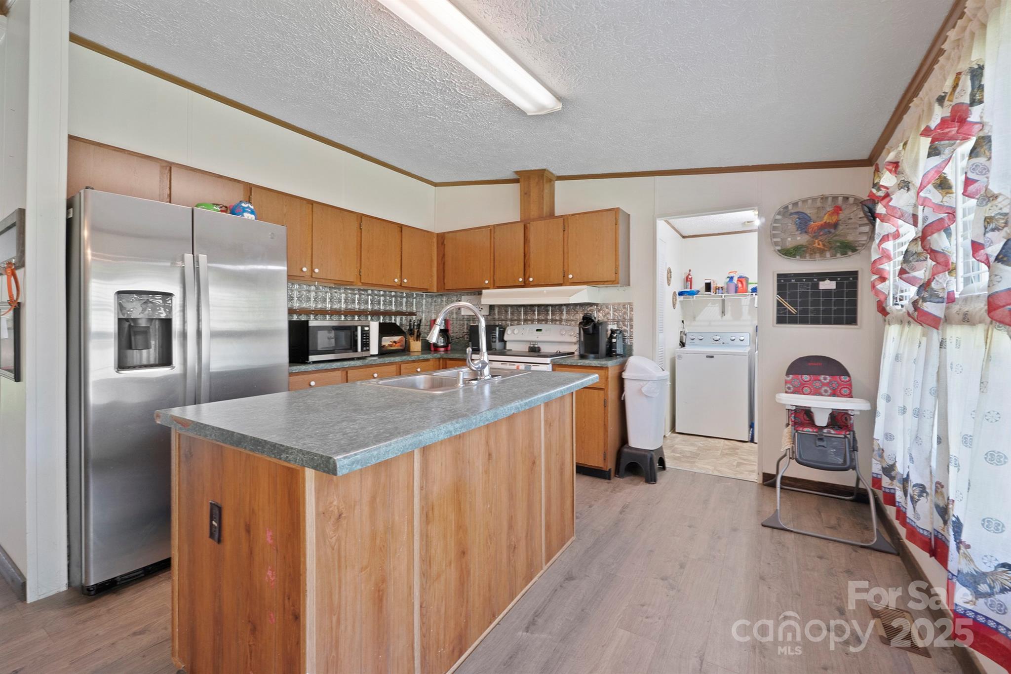 6282 Lor Road Morganton, NC 28655 - Photo 8 of 22 a kitchen with refrigerator and cabinets