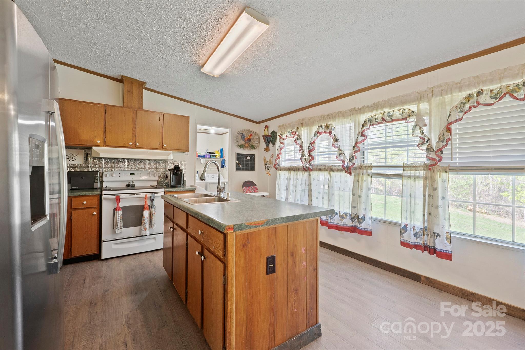 6282 Lor Road Morganton, NC 28655 - Photo 9 of 22 a kitchen with stainless steel appliances granite countertop a stove and a refrigerator