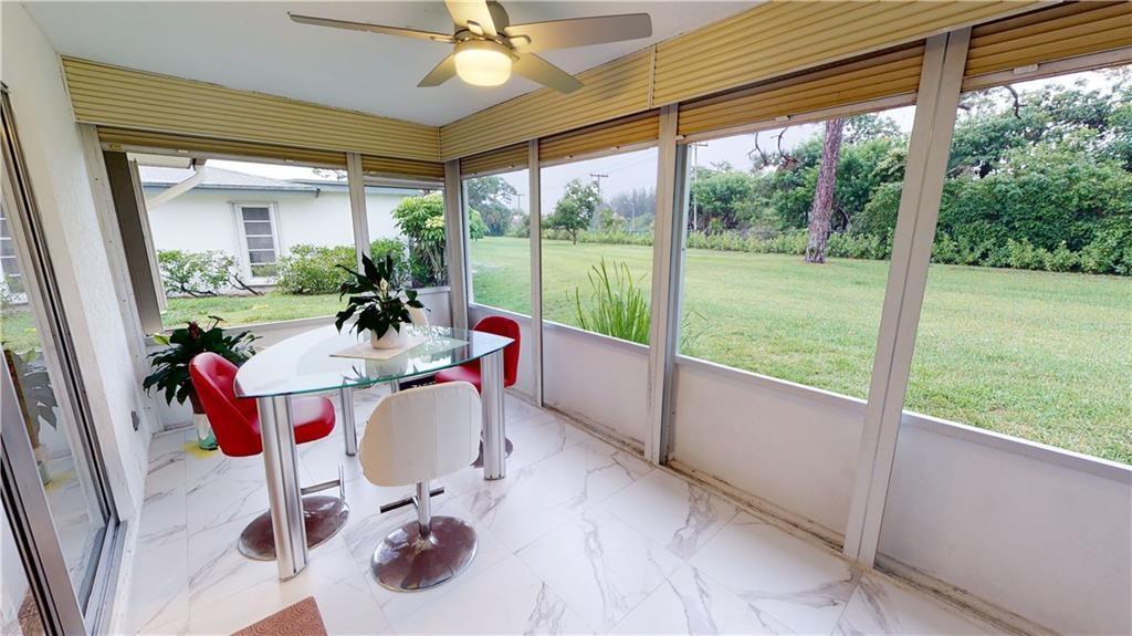5388 Privet Place, Unit A Delray Beach, FL 33484 - Photo 14 of 33 a living room with patio furniture and a floor to ceiling window