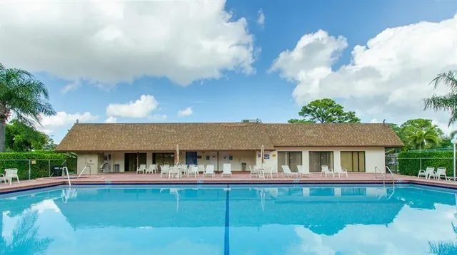 a front view of house with yard swimming pool and outdoor seating