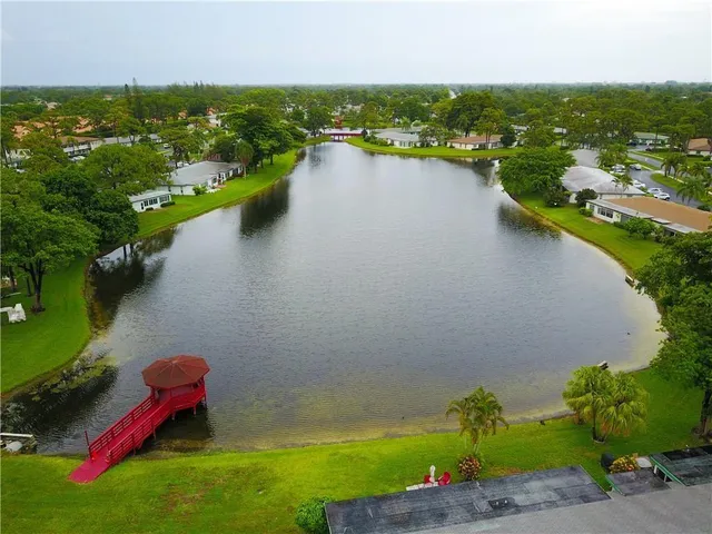 an aerial view of a houses with a lake view