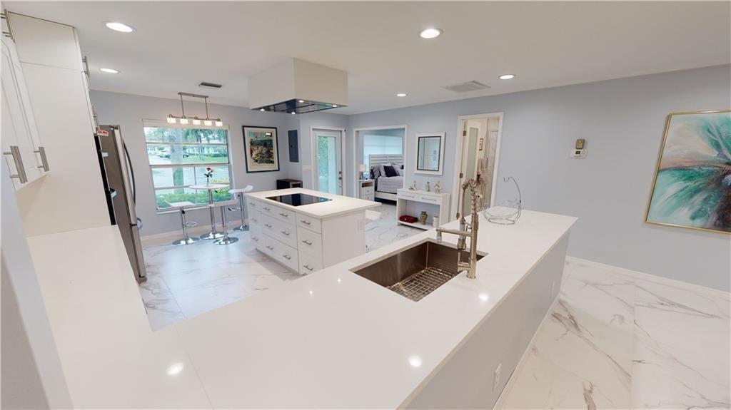 5388 Privet Place, Unit A Delray Beach, FL 33484 - Photo 3 of 33 a living room with furniture large window and flat screen tv