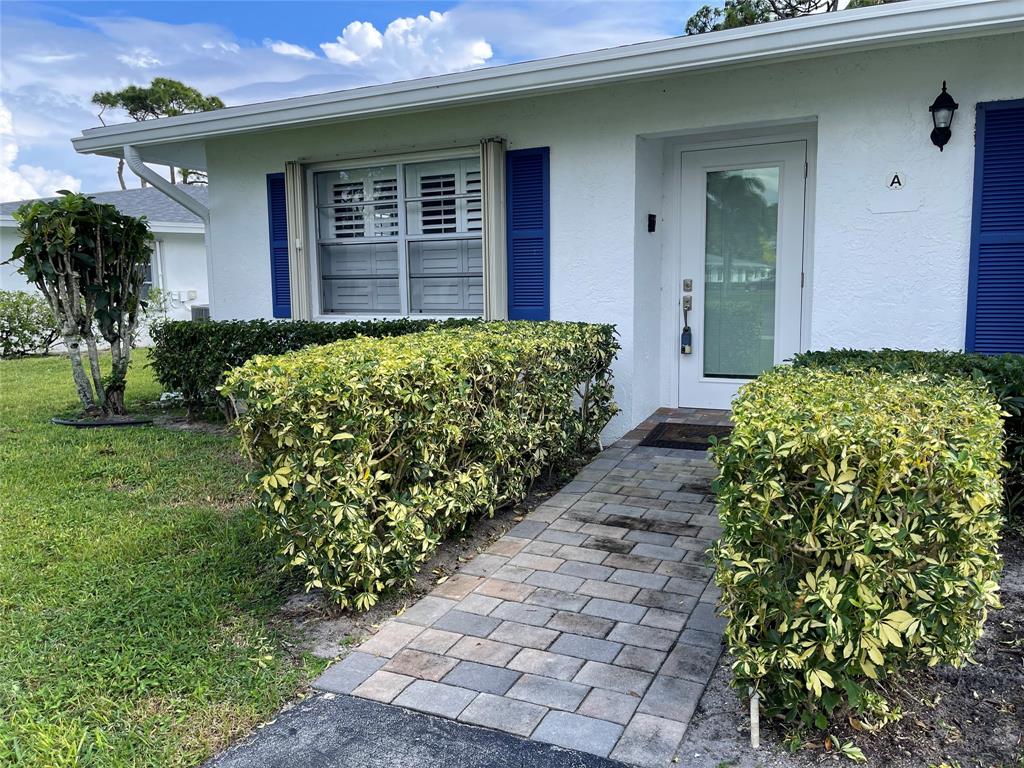 5388 Privet Place, Unit A Delray Beach, FL 33484 - Photo 32 of 33 a front view of a house with garden