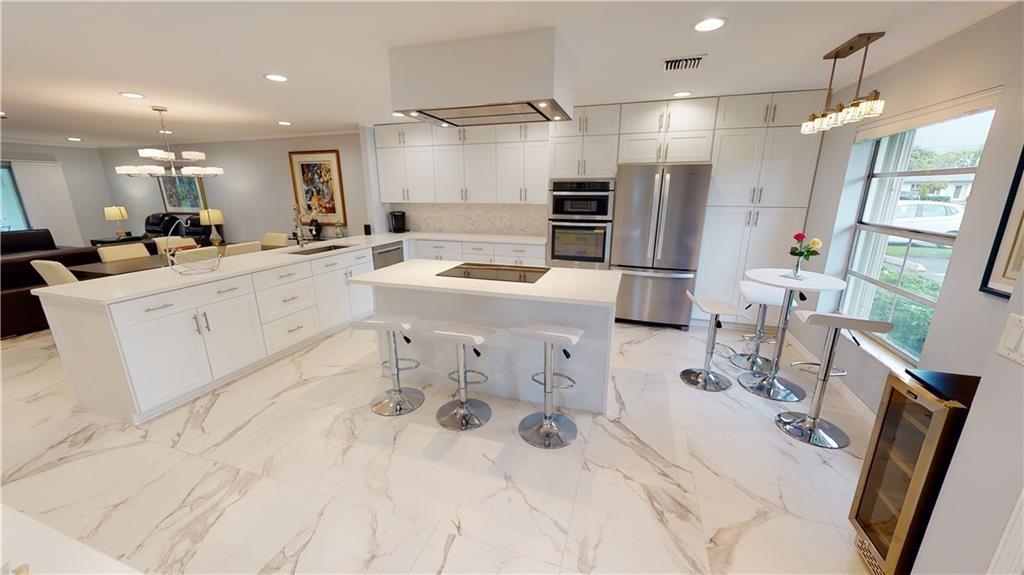 5388 Privet Place, Unit A Delray Beach, FL 33484 - Photo 4 of 33 a large white kitchen with a large window