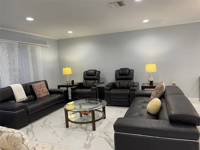 a living room with furniture and a lamp