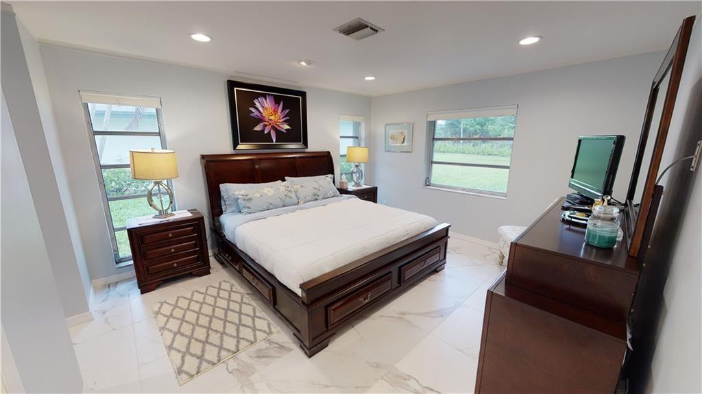 5388 Privet Place, Unit A Delray Beach, FL 33484 - Photo 8 of 33 a bedroom with a bed and furniture