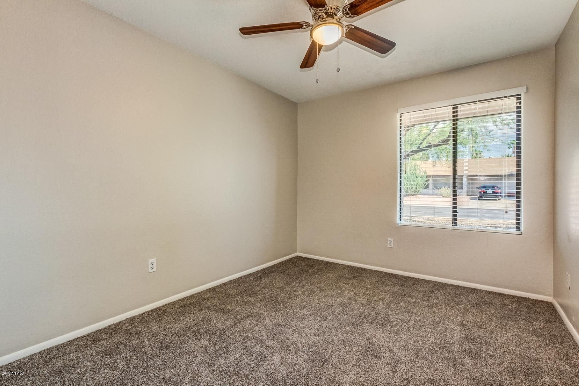 4833 East Kathleen Road Scottsdale, AZ 85254 - Photo 12 of 21 an empty room with a window and a fan