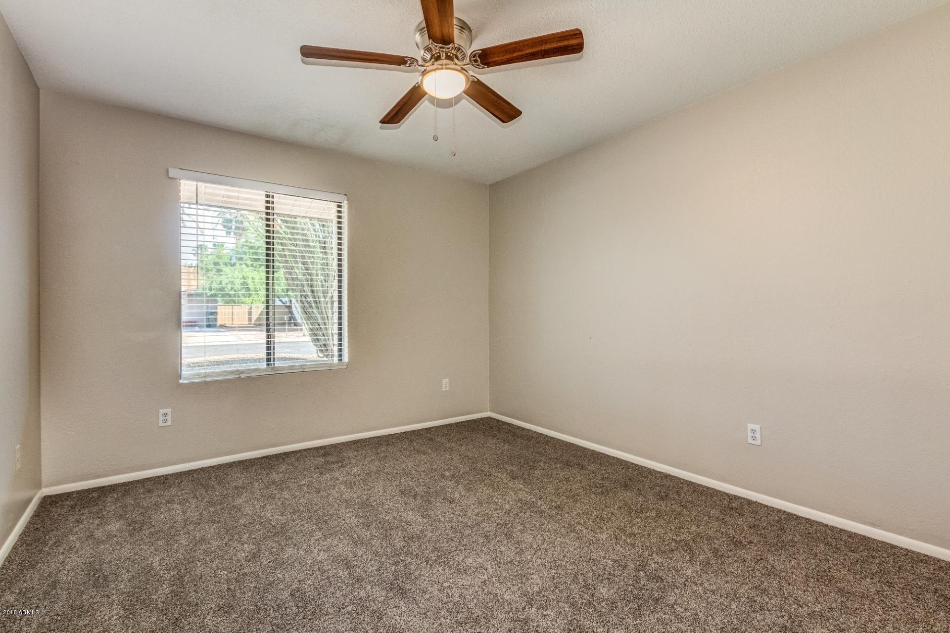 4833 East Kathleen Road Scottsdale, AZ 85254 - Photo 13 of 21 an empty room with a window and a fan