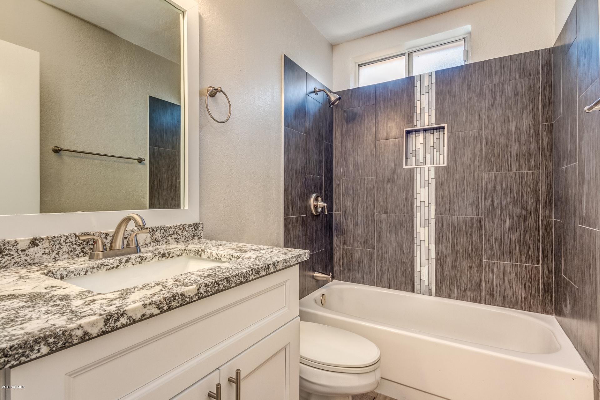 4833 East Kathleen Road Scottsdale, AZ 85254 - Photo 14 of 21 a bathroom with a granite countertop bathtub shower sink vanity and toilet