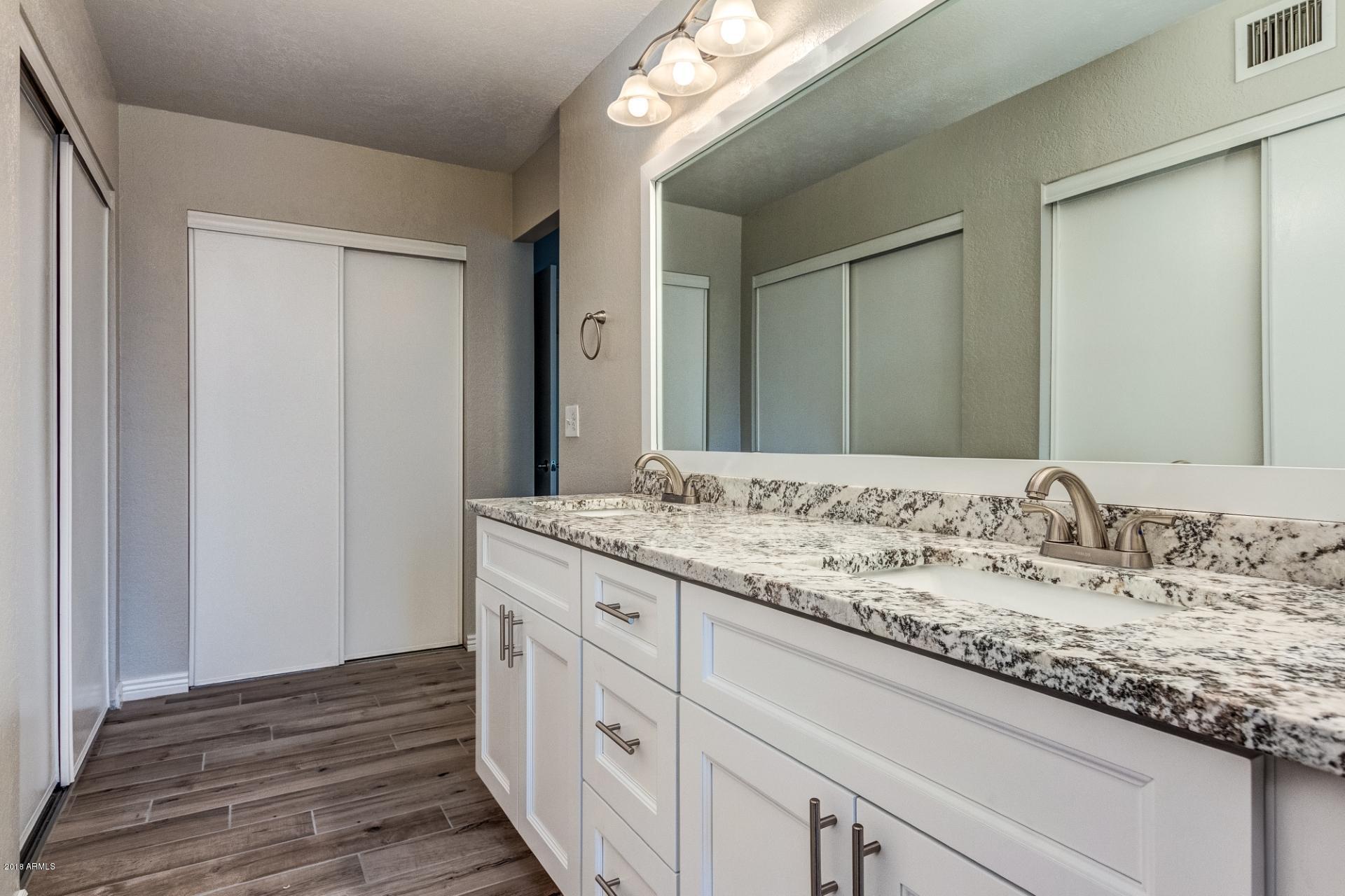 4833 East Kathleen Road Scottsdale, AZ 85254 - Photo 17 of 21 a bathroom with a granite countertop sink and a mirror
