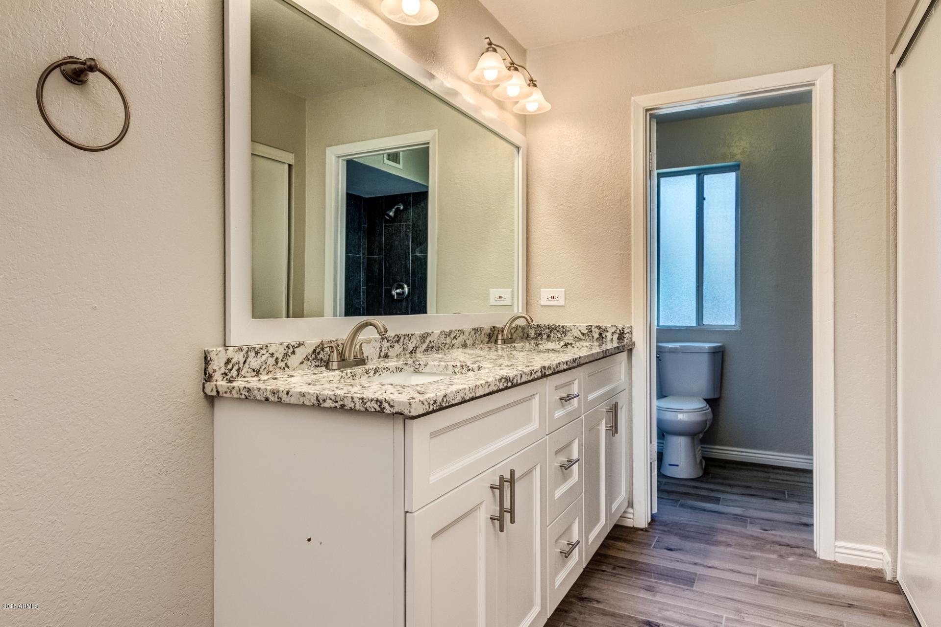 4833 East Kathleen Road Scottsdale, AZ 85254 - Photo 19 of 21 a bathroom with a granite countertop sink and a mirror