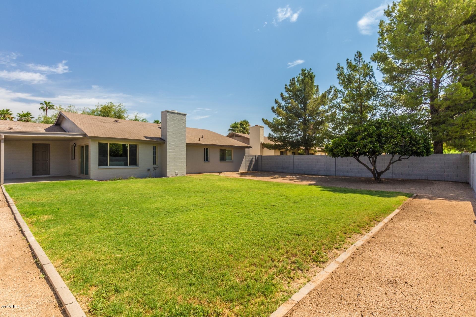 4833 East Kathleen Road Scottsdale, AZ 85254 - Photo 21 of 21 a front view of a house with a garden