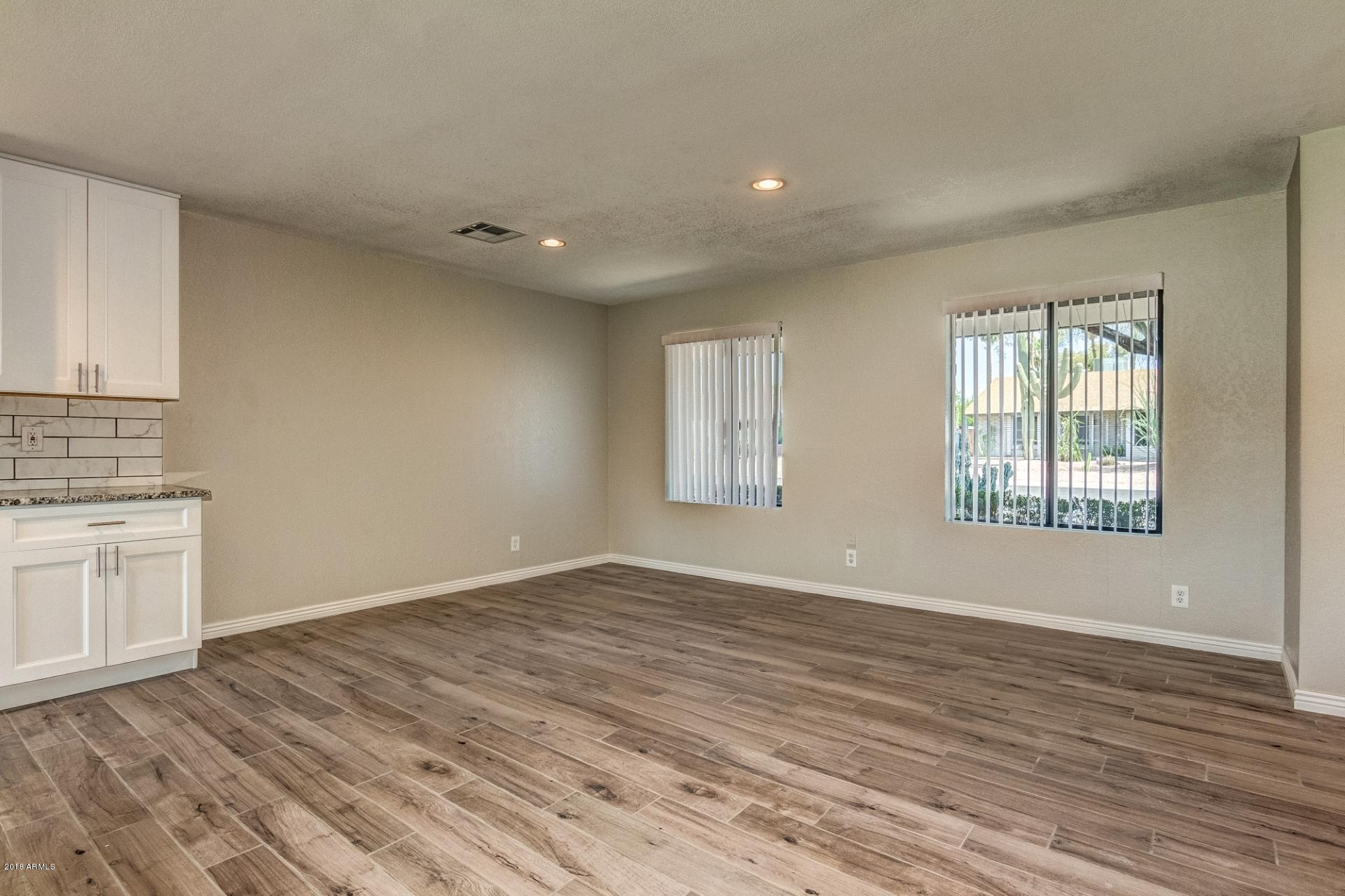 4833 East Kathleen Road Scottsdale, AZ 85254 - Photo 4 of 21 wooden floor in an empty room with a window