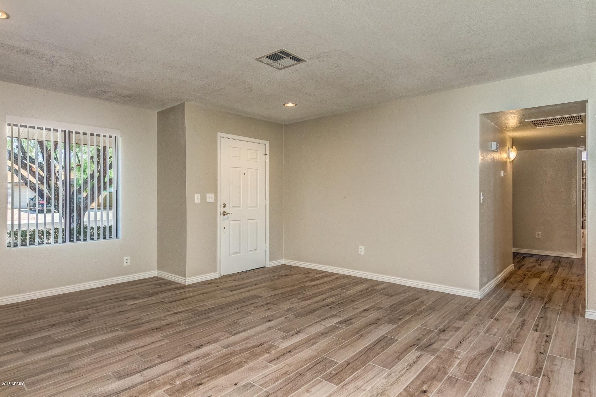 4833 East Kathleen Road Scottsdale, AZ 85254 - Photo 6 of 21 a view of wooden floor and windows in a room