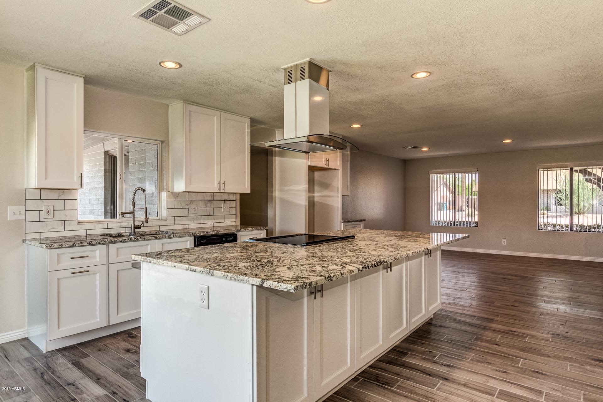 4833 East Kathleen Road Scottsdale, AZ 85254 - Photo 8 of 21 a kitchen with stainless steel appliances granite countertop a sink stove and cabinets