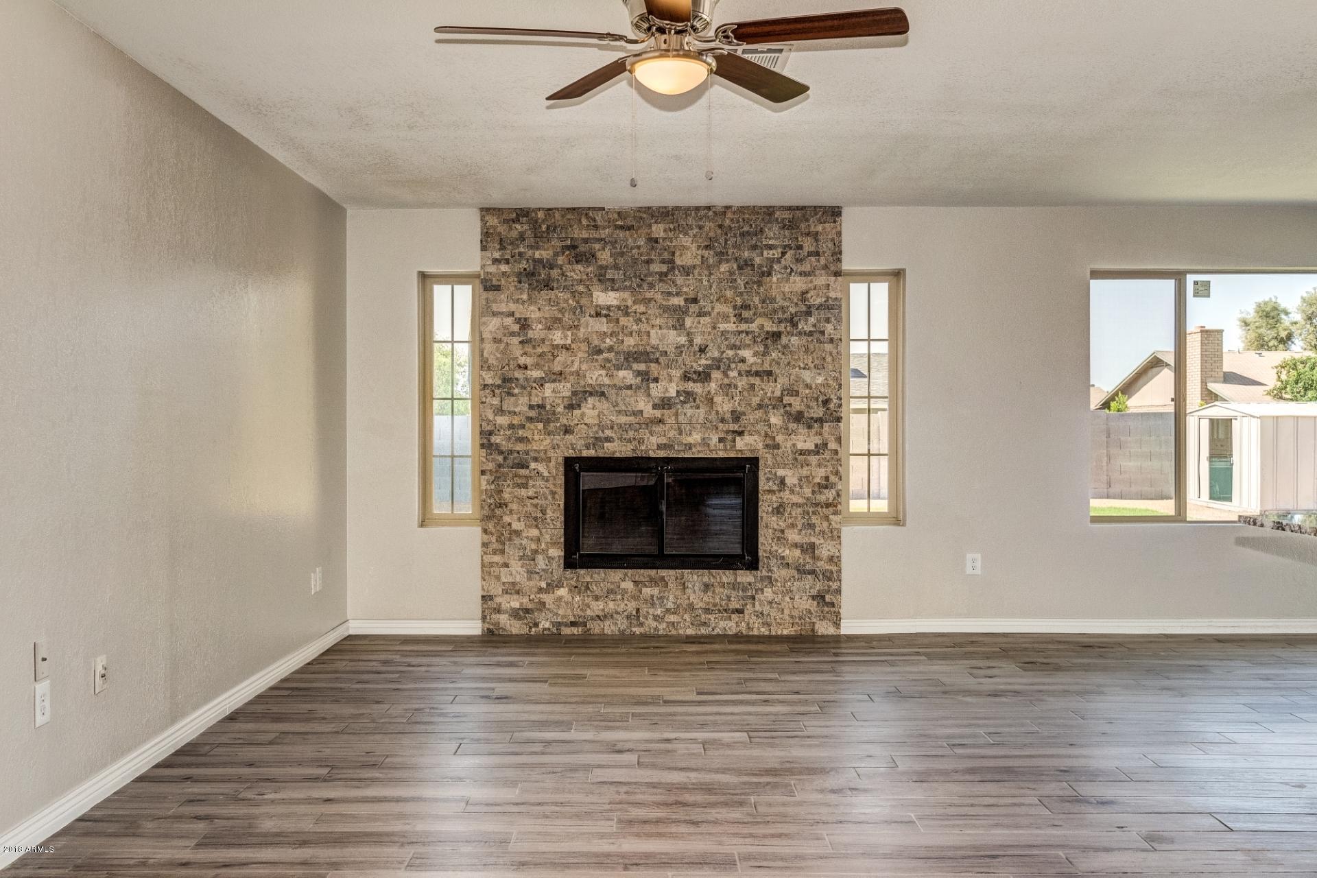 4833 East Kathleen Road Scottsdale, AZ 85254 - Photo 9 of 21 a view of a livingroom with a fireplace and window
