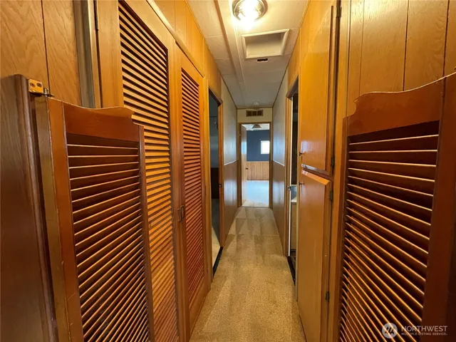 a bedroom with a bed couch and painting on the wall