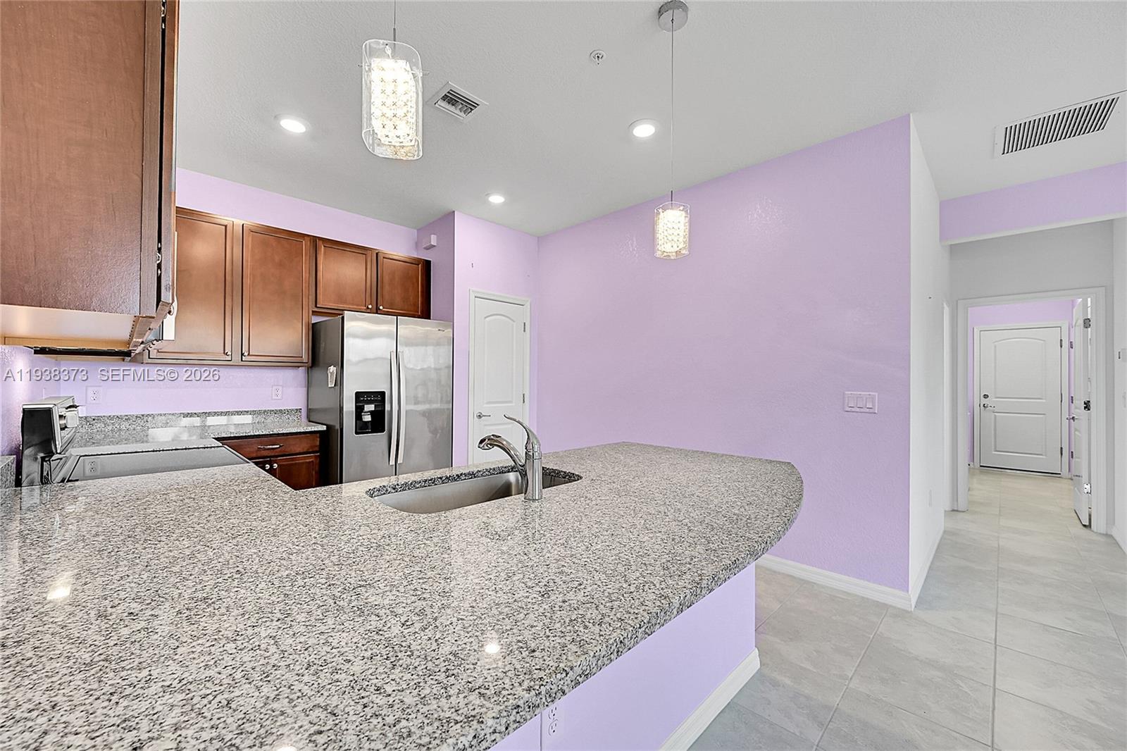 9145 Passiflora Way Boca Raton, FL 33428 - Photo 11 of 54 a kitchen with granite countertop a sink stainless steel appliances and cabinets