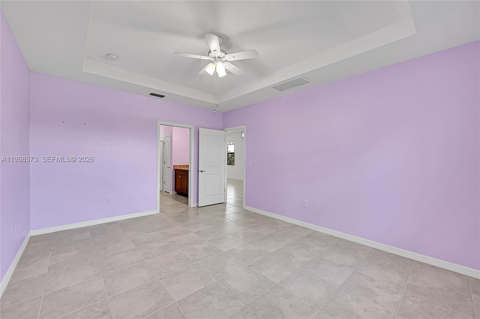 9145 Passiflora Way Boca Raton, FL 33428 - Photo 14 of 54 a view of an empty room with a chandelier fan