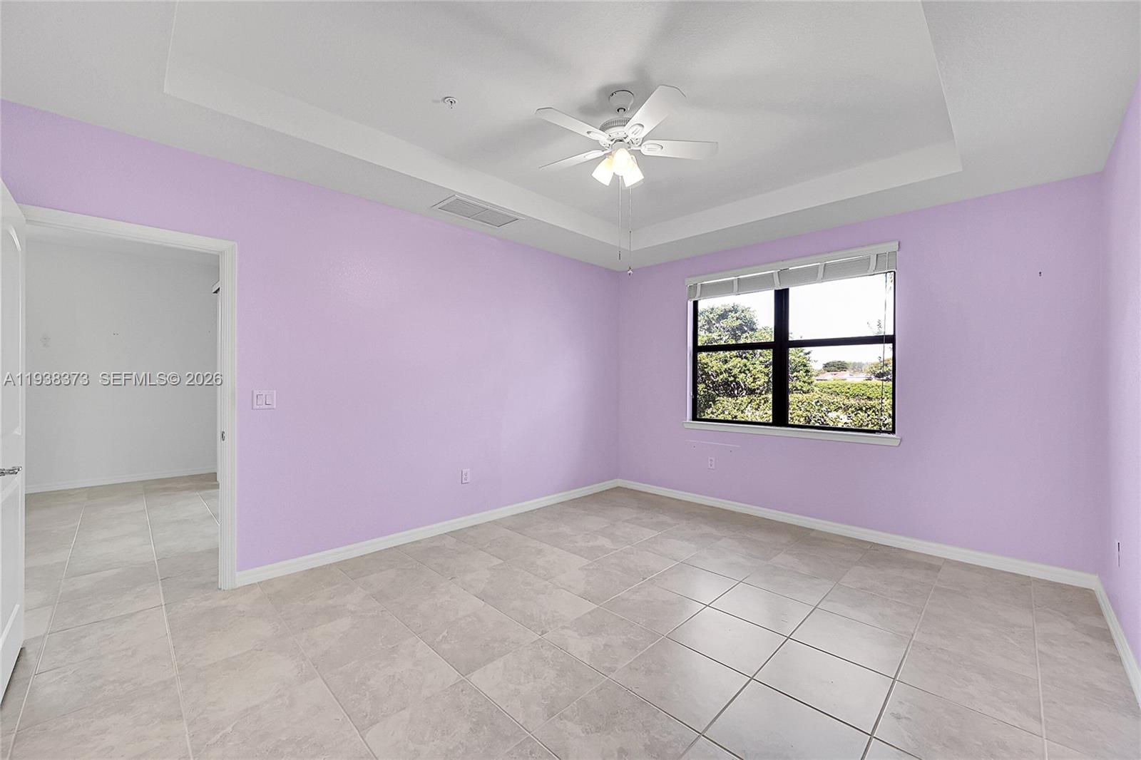 9145 Passiflora Way Boca Raton, FL 33428 - Photo 15 of 54 an empty room with windows and chandelier fan
