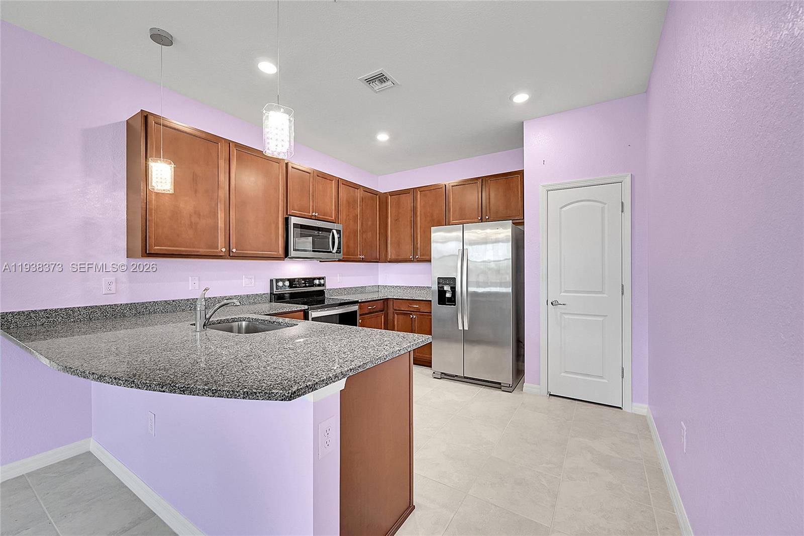 9145 Passiflora Way Boca Raton, FL 33428 - Photo 8 of 54 a kitchen with stainless steel appliances granite countertop a sink refrigerator and cabinets