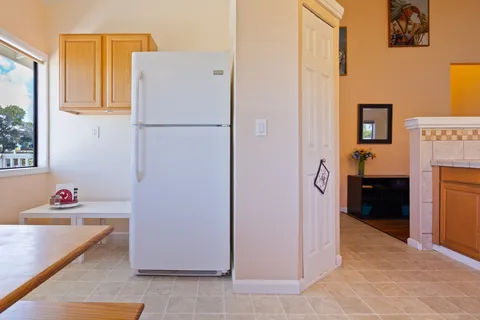 a kitchen with stainless steel appliances granite countertop a refrigerator and a stove