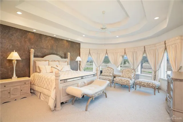 a spacious bedroom with a bed and a couch