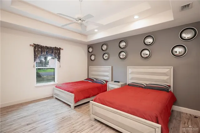 a bedroom with two beds and a table