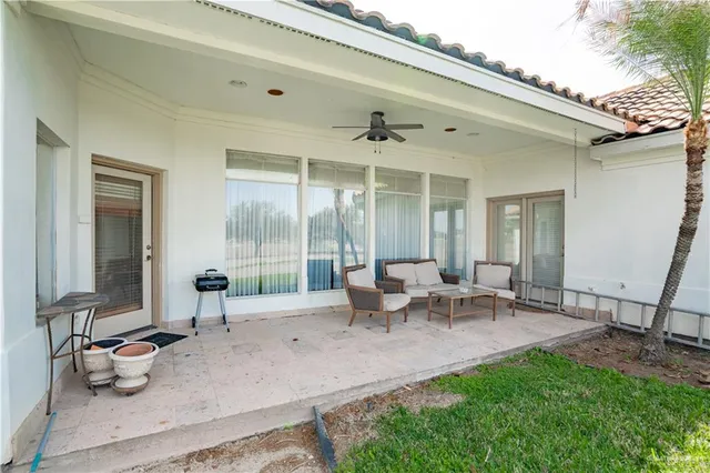 a view of a patio with table and chairs and potted plants