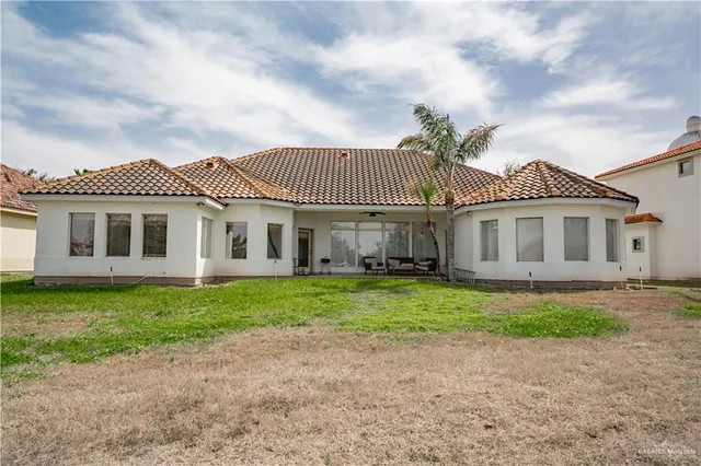 a front view of a house with a garden and yard