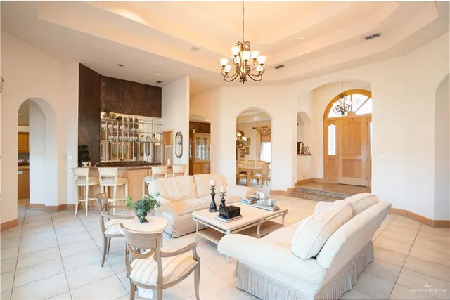 a living room with fireplace furniture and a chandelier