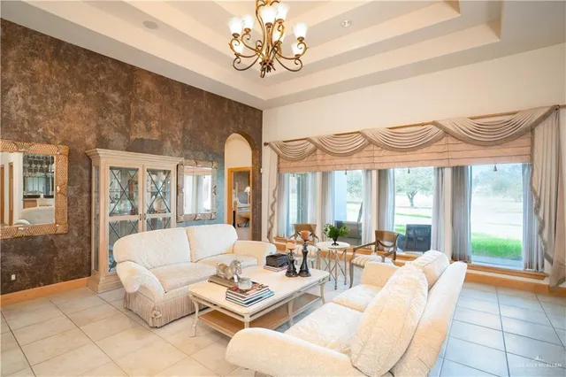 a living room with fireplace furniture and a large window