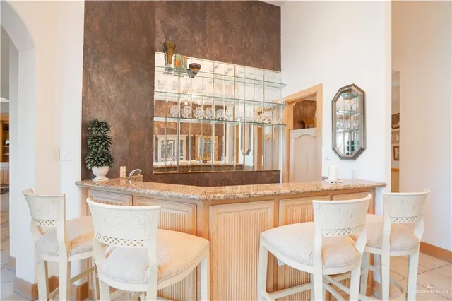 a white kitchen with a dining table and chairs