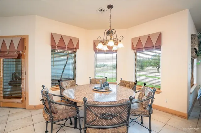 a dining room with furniture a chandelier and window