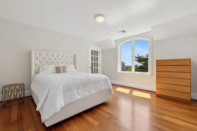 a living room with a bed and a chair