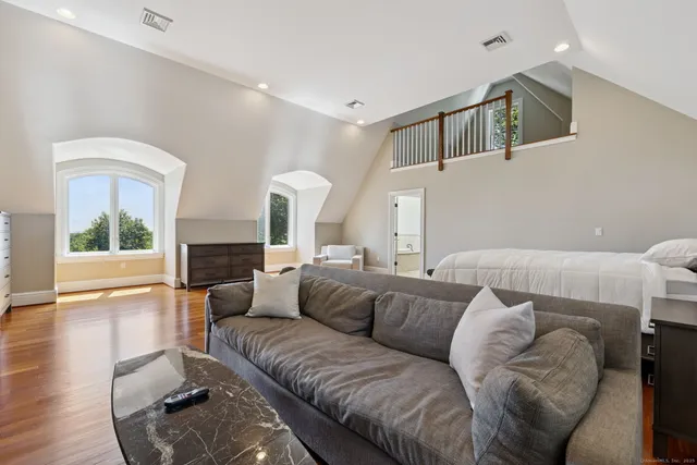 a large bedroom with bed and fireplace