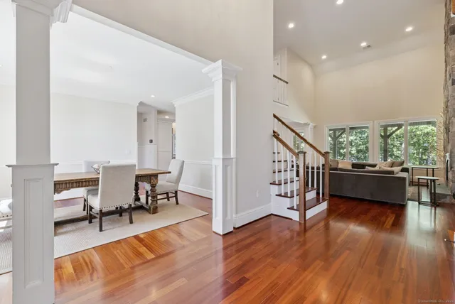a living room with furniture and a hard wood floor