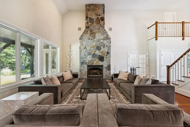 a kitchen with stainless steel appliances granite countertop a sink a stove and a wooden floors