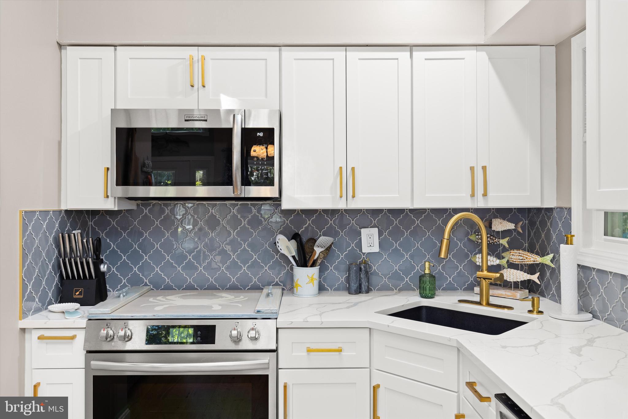 4 Haven End Ocean Pines, MD 21811 - Photo 13 of 37 a kitchen with a stove and a white cabinets