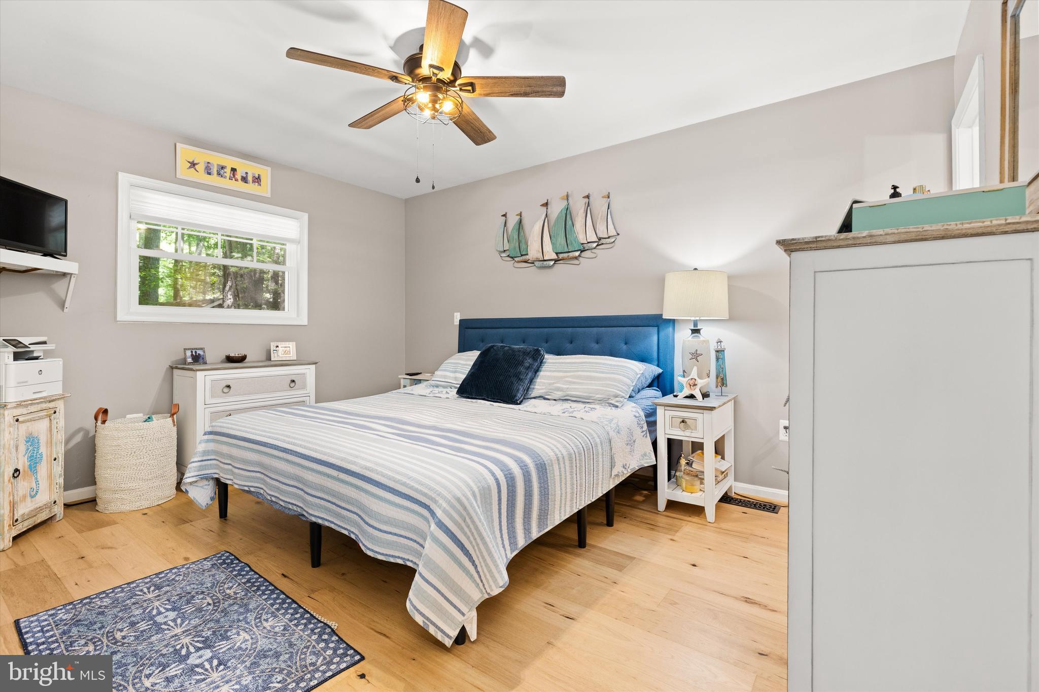 4 Haven End Ocean Pines, MD 21811 - Photo 15 of 37 a bedroom with a bed and a chandelier